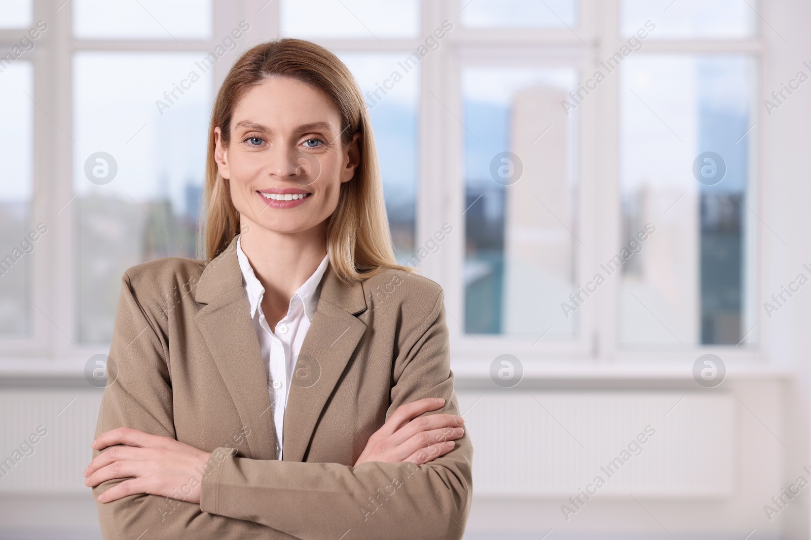 Photo of Happy real estate agent in new apartment. Space for text