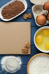 Blank recipe book and different ingredients on blue wooden table, flat lay. Space for text