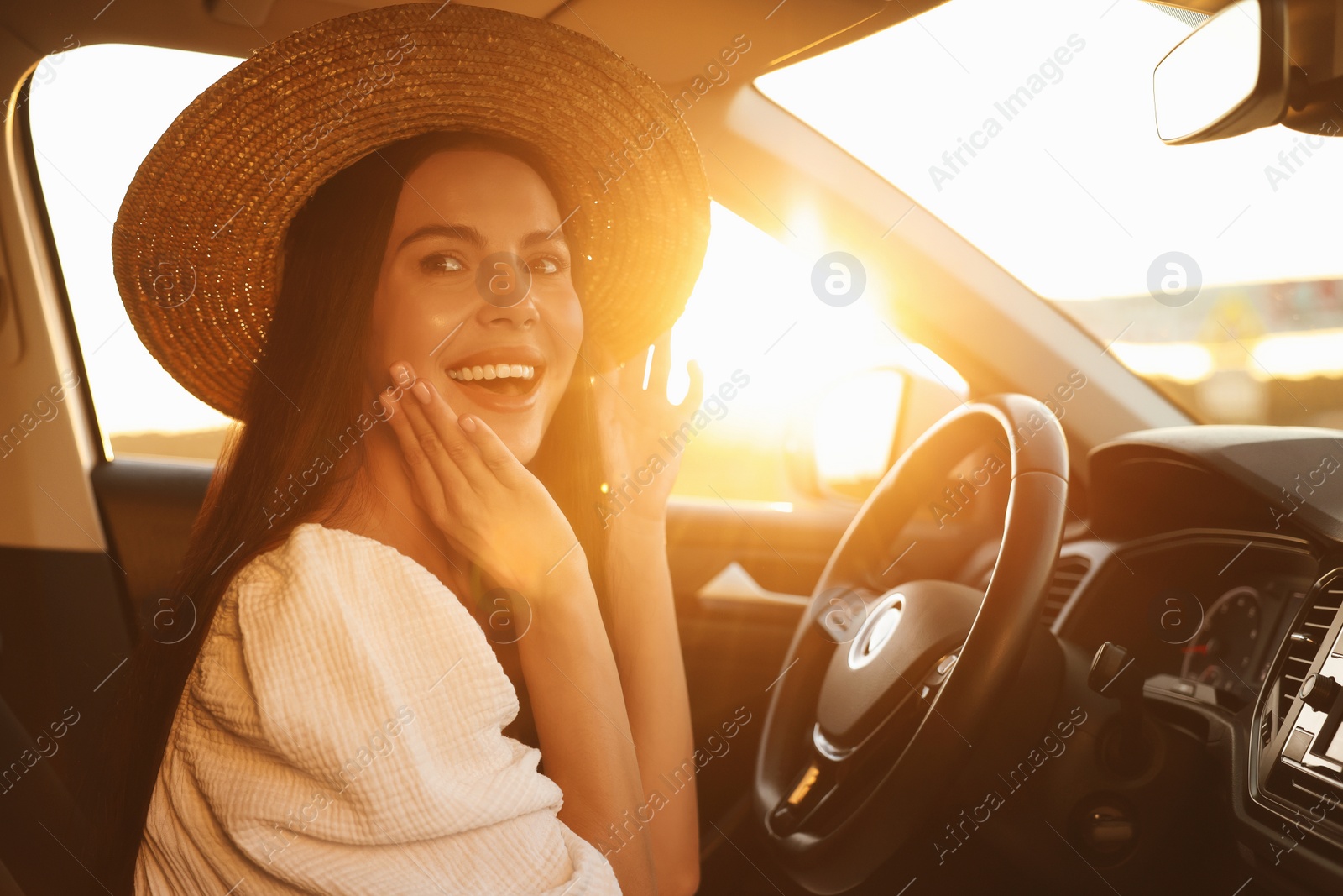 Photo of Beautiful young woman sitting in her car. Enjoying trip