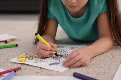 Photo of Child coloring drawing on floor at home, closeup