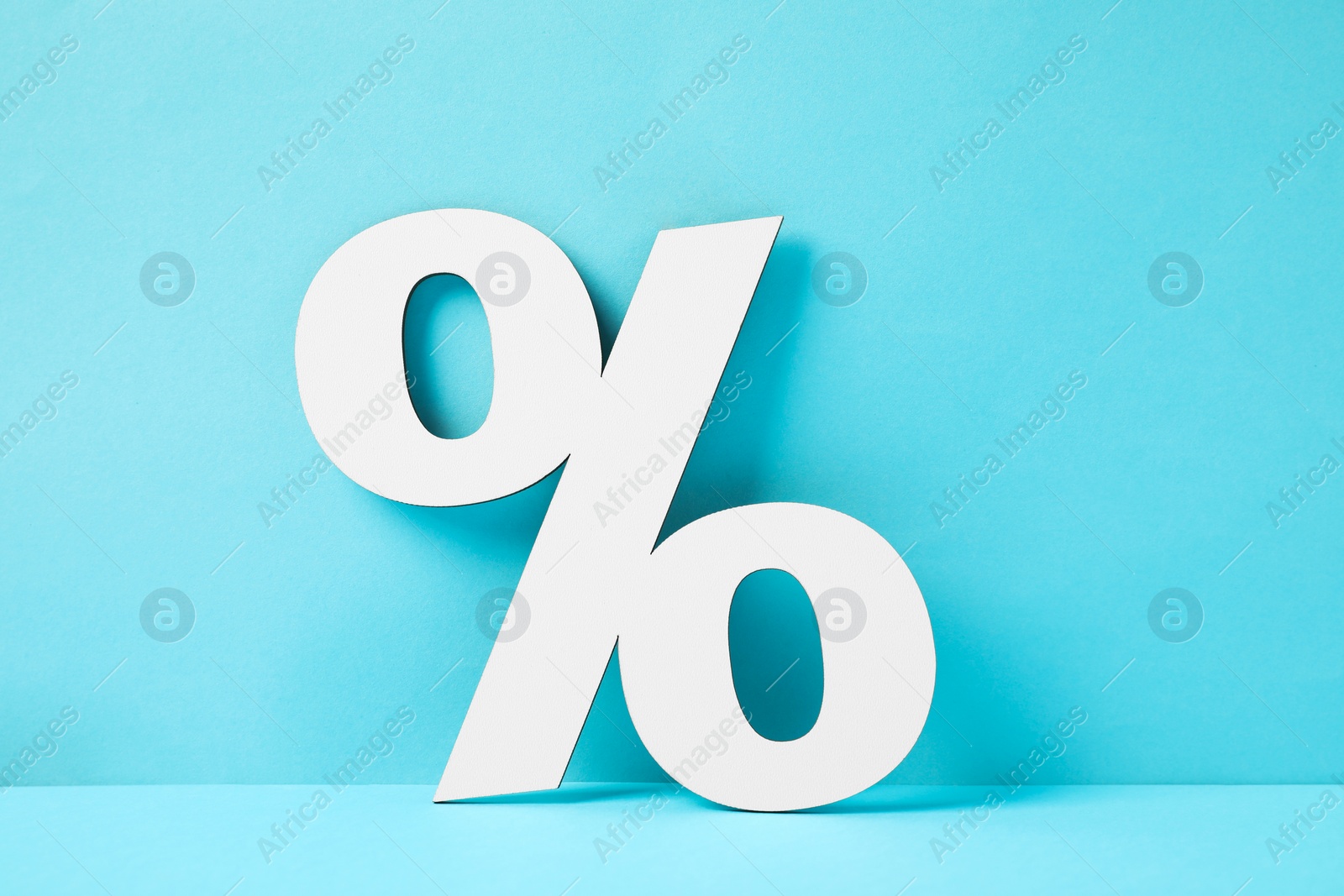 Photo of White percent sign on light blue background