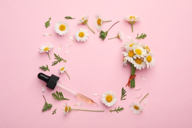 Photo of Flat lay composition with chamomile flowers and pipette of essential oil on color background. Space for text