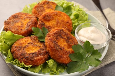 Photo of Tasty vegan cutlets with sauce on plate, closeup