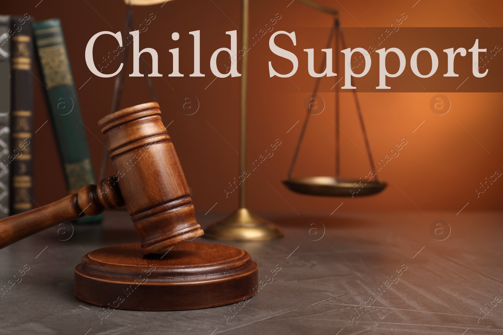 Image of Judge's gavel, scales of justice and books on wooden table. Child support concept