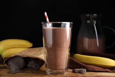 Fresh yummy chocolate milk on wooden table