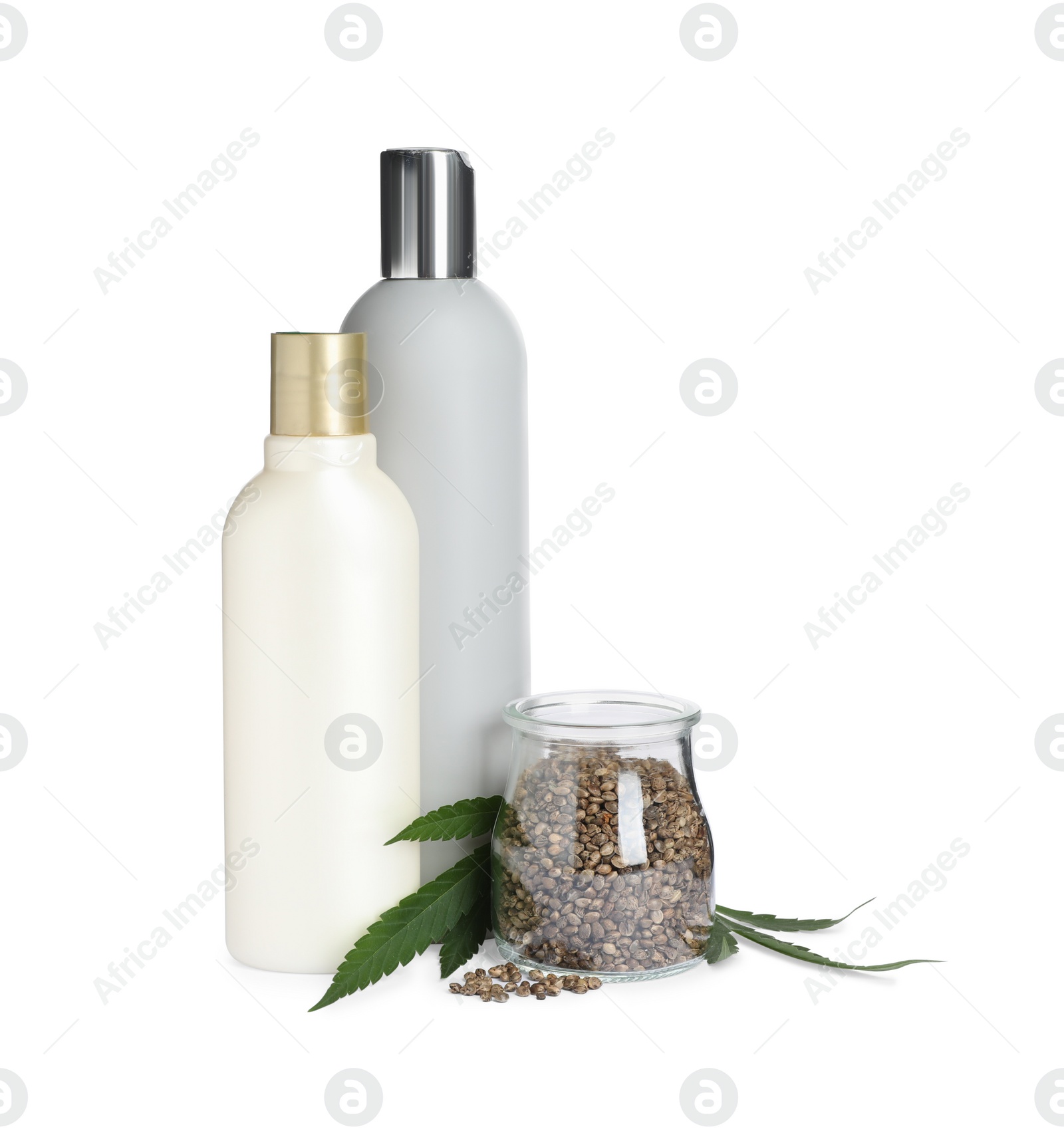 Photo of Set of hemp cosmetics with green leaves and seeds isolated on white