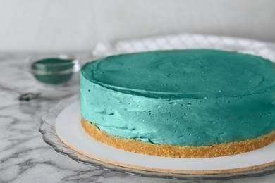 Photo of Delicious homemade spirulina cheesecake on marble table