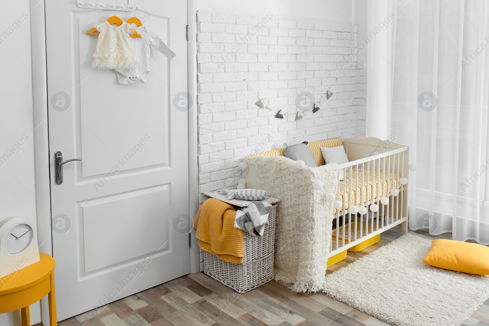 Photo of Stylish baby room interior with crib