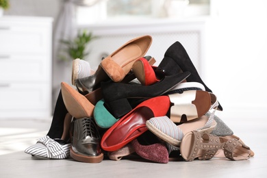 Photo of Pile of female shoes on floor indoors