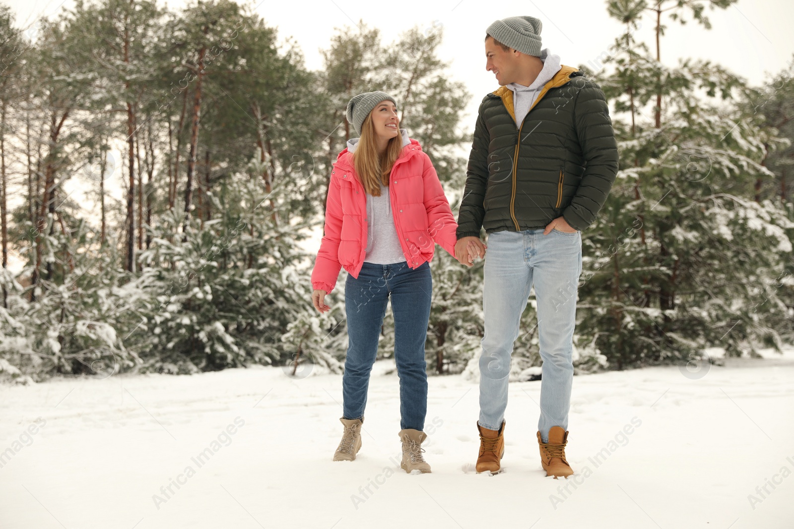 Photo of Beautiful happy couple in snowy forest on winter day