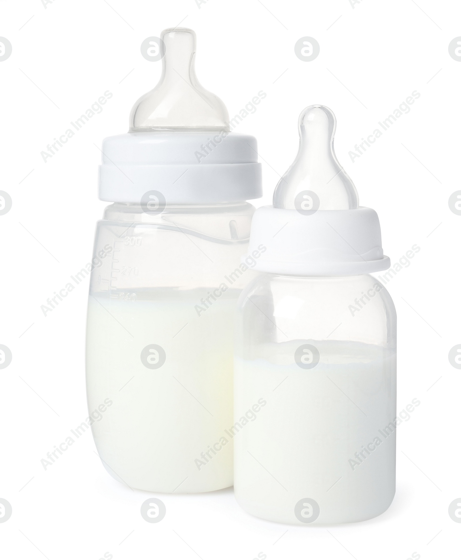 Photo of Two feeding bottles with infant formula on white background