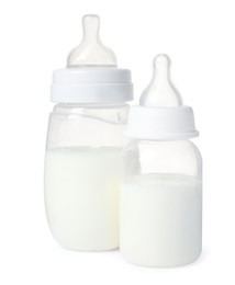Photo of Two feeding bottles with infant formula on white background