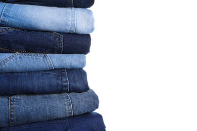 Photo of Stack of different jeans isolated on white