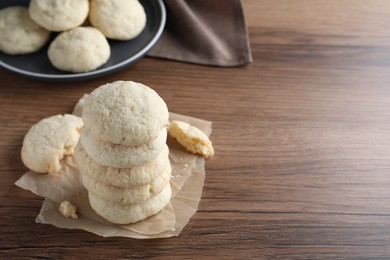 Photo of Stack of tasty sugar cookies on wooden table. Space for text