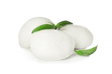 Delicious mozzarella cheese balls and basil on white background