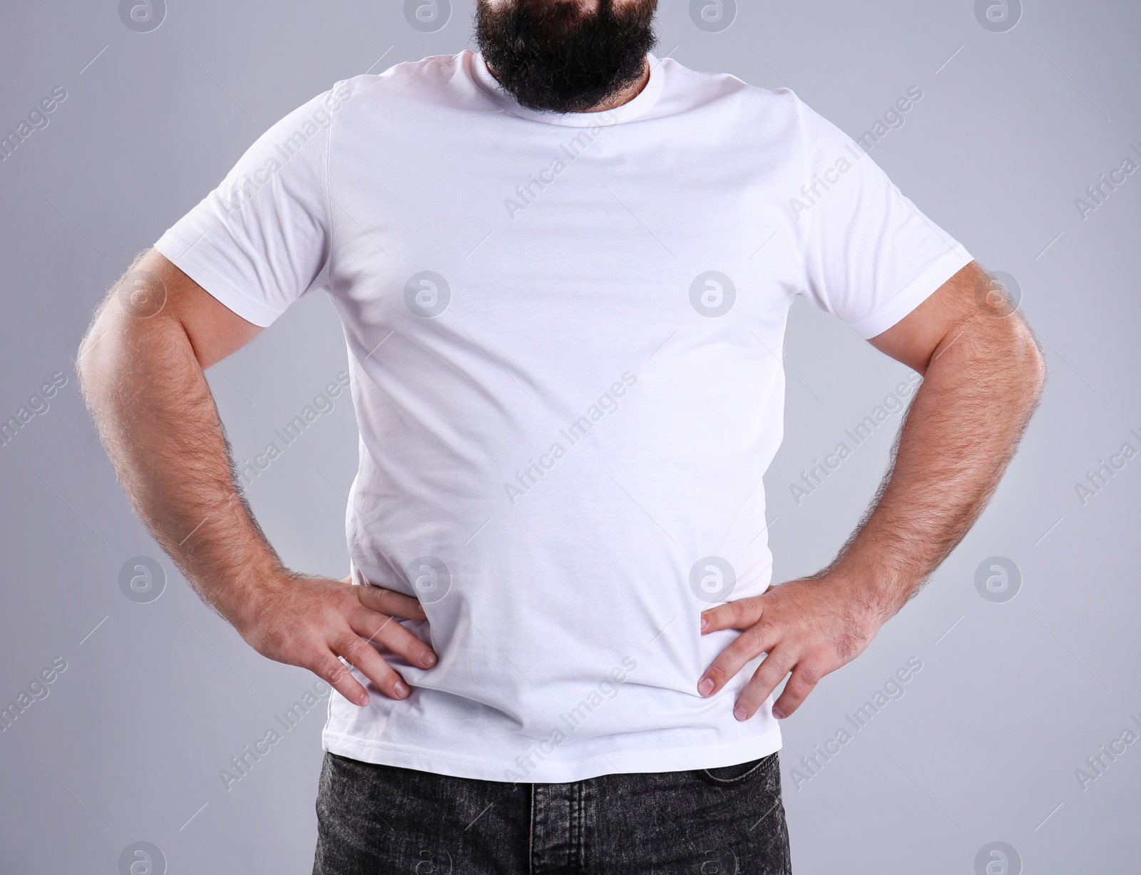 Photo of Fat man on grey background, closeup. Weight loss