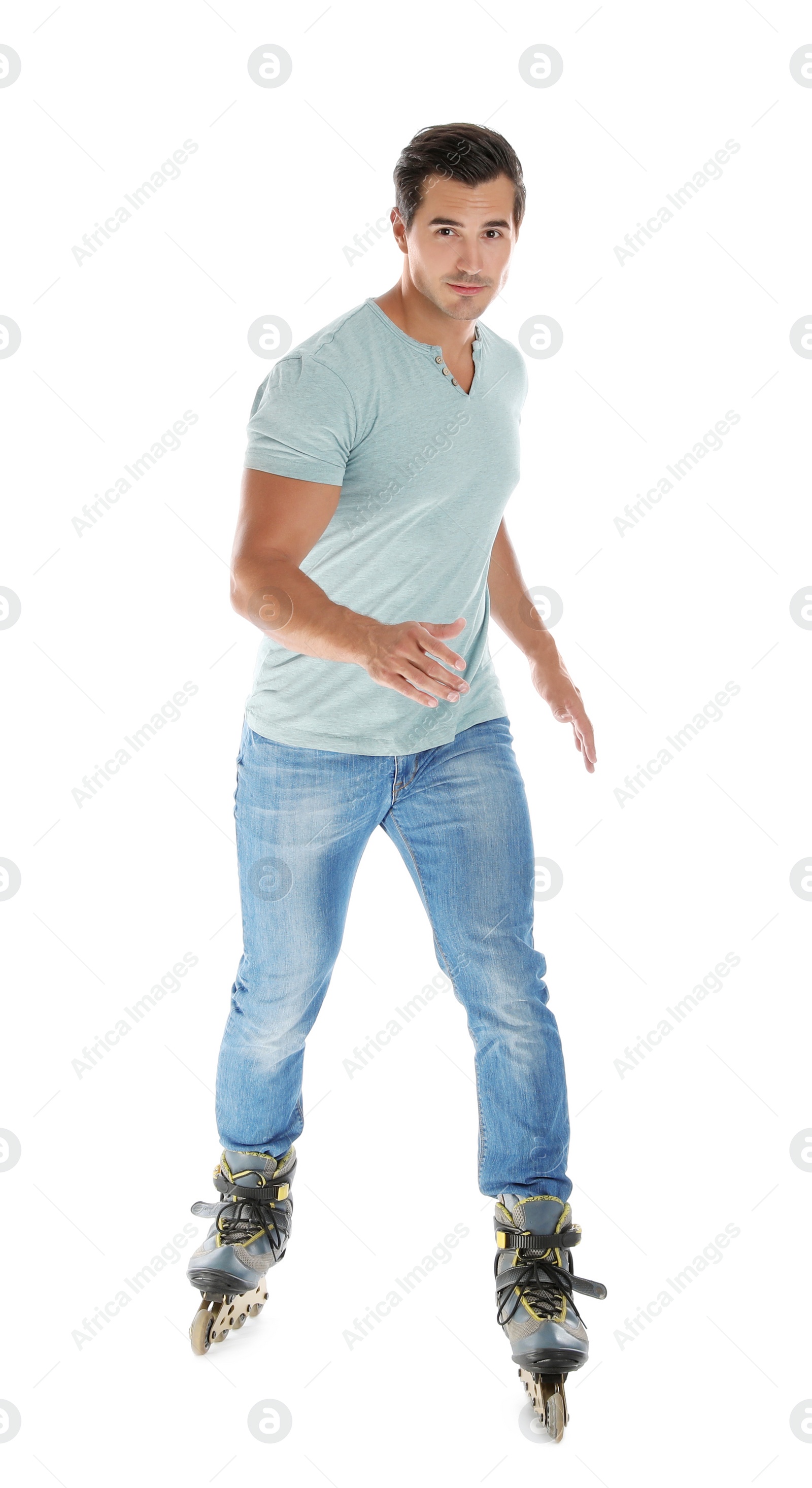 Photo of Handsome young man with inline roller skates on white background