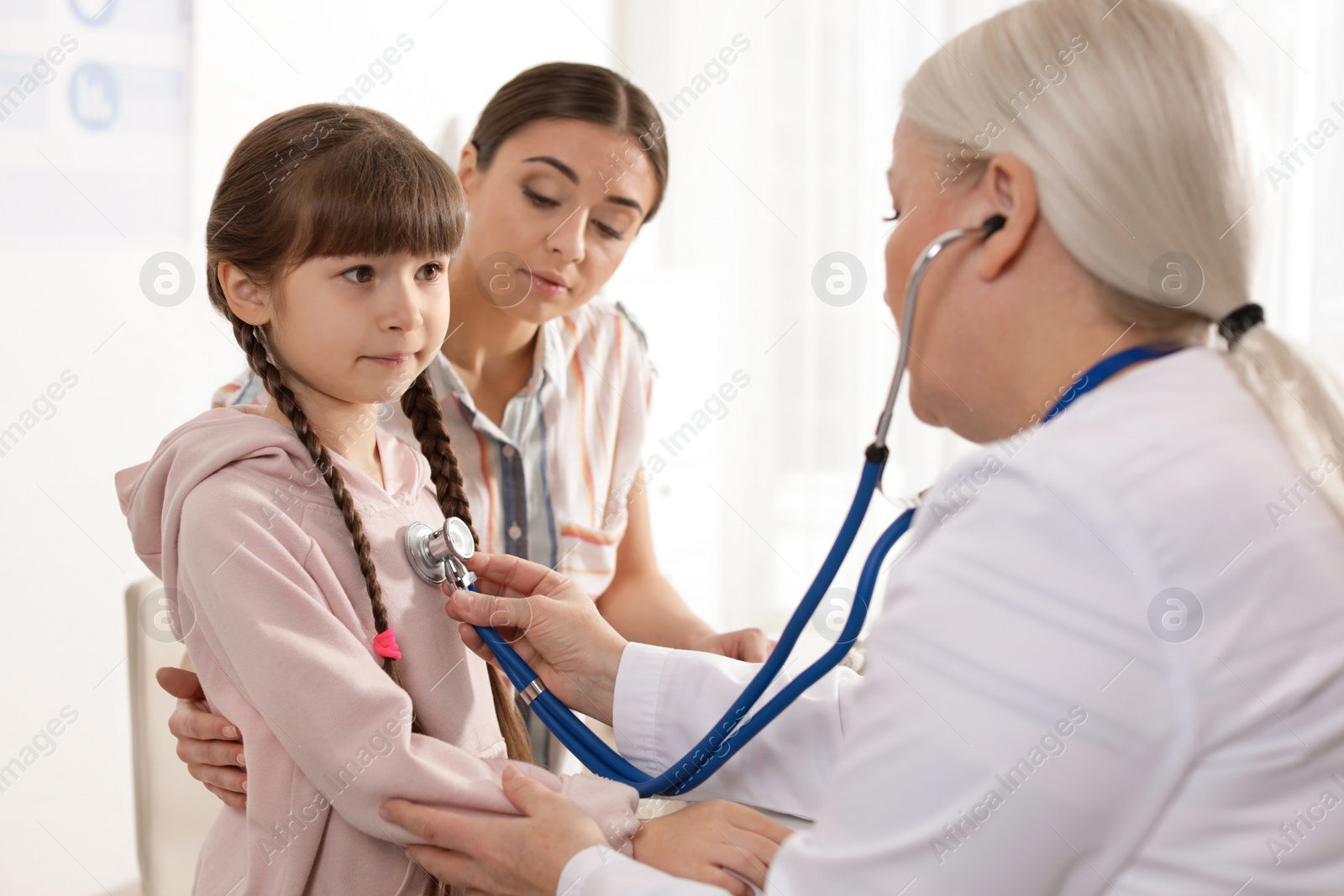 Photo of Mother with child visiting doctor in hospital