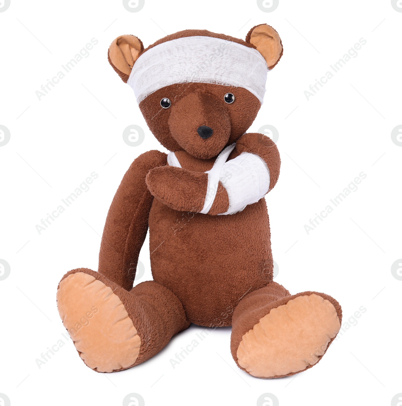 Photo of Toy bear with bandages isolated on white