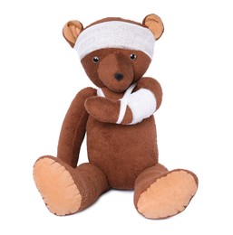 Photo of Toy bear with bandages isolated on white