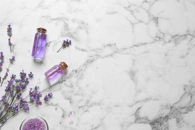 Photo of Flat lay composition with natural cosmetic products and lavender flowers on marble background. Space for text