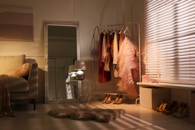 Modern dressing room interior with clothing rack and mirror