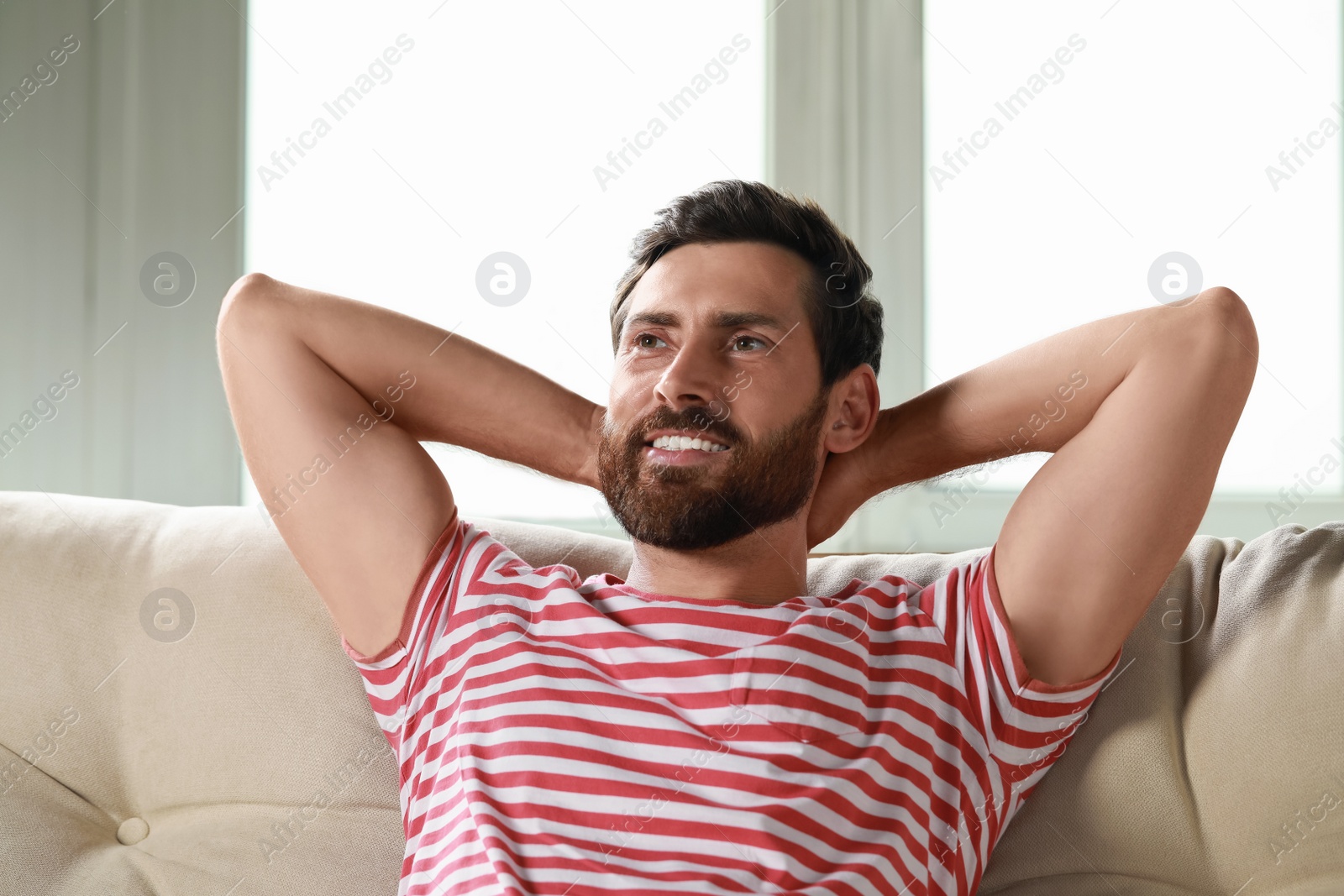 Photo of Portrait of handsome bearded man on sofa at home