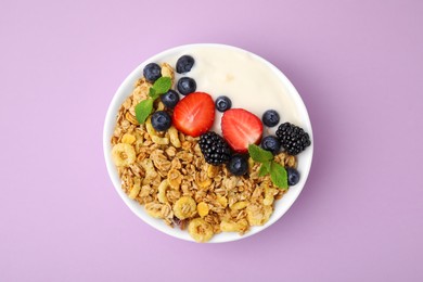 Photo of Tasty oatmeal, yogurt and fresh berries in bowl on lilac background, top view. Healthy breakfast
