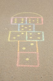 Hopscotch drawn with colorful chalk on asphalt outdoors