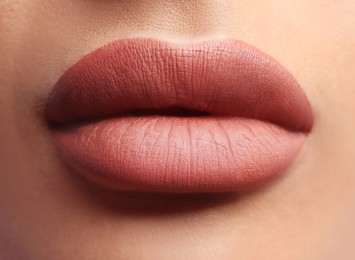 Image of Woman with beautiful perfect lips after permanent makeup procedure, closeup