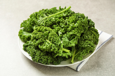 Photo of Fresh kale leaves on light grey table