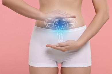 Image of Woman in underwear and illustration of reproductive system on pink background, closeup