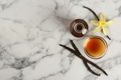 Homemade vanilla extract on marble table, flat lay. Space for text