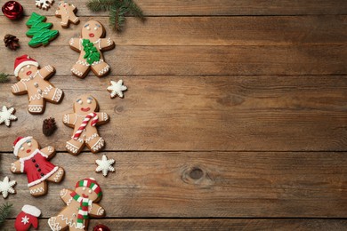 Photo of Delicious Christmas cookies and festive decor on wooden table, flat lay. Space for text