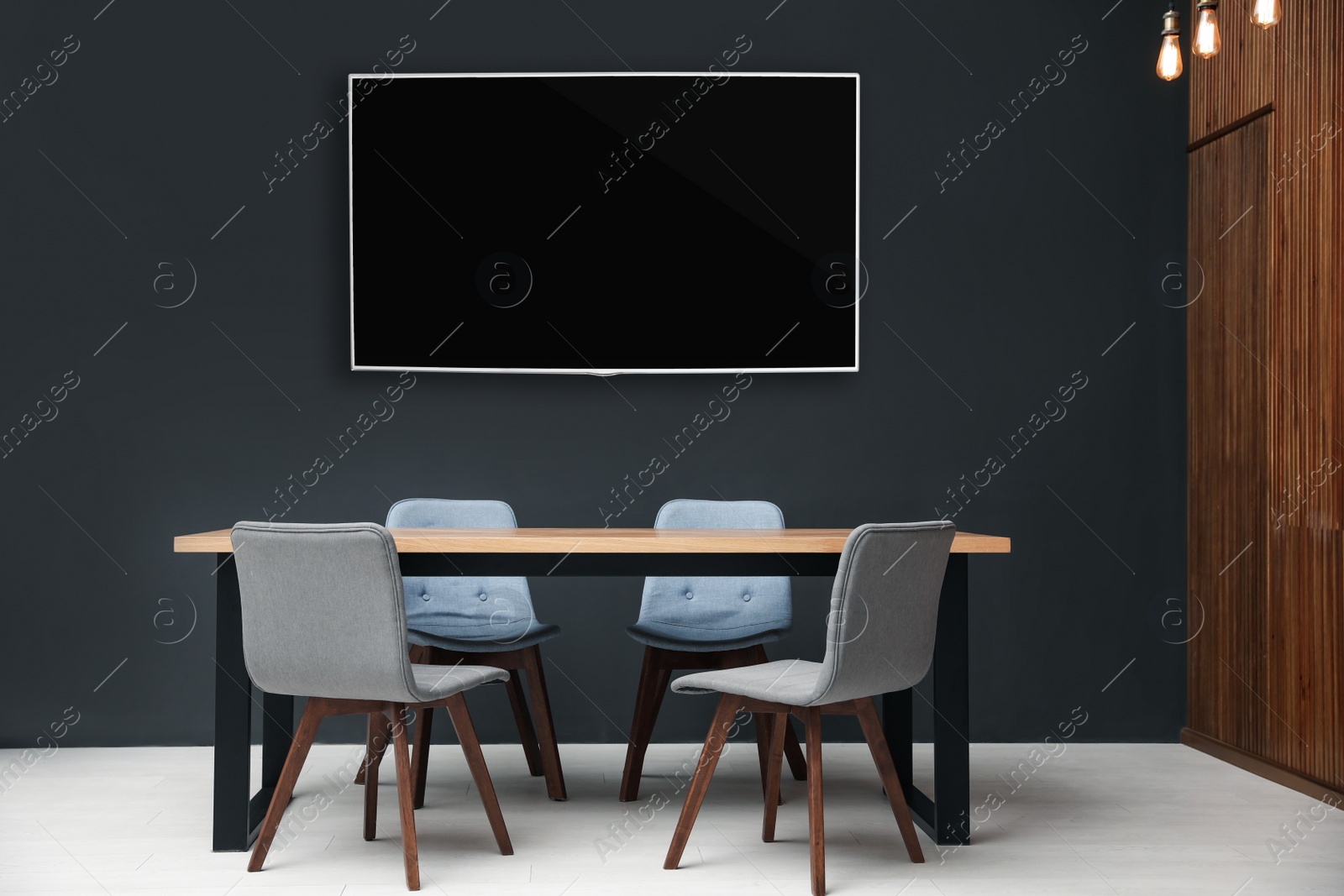 Image of Modern wide screen TV on black wall in room with stylish furniture 