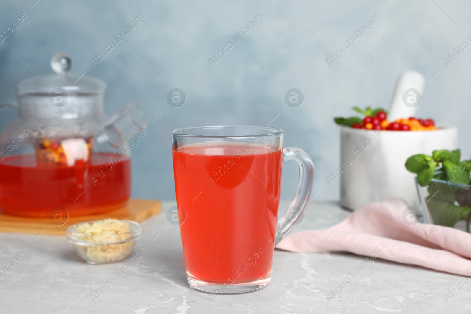 Photo of Immunity boosting drink on light grey marble table