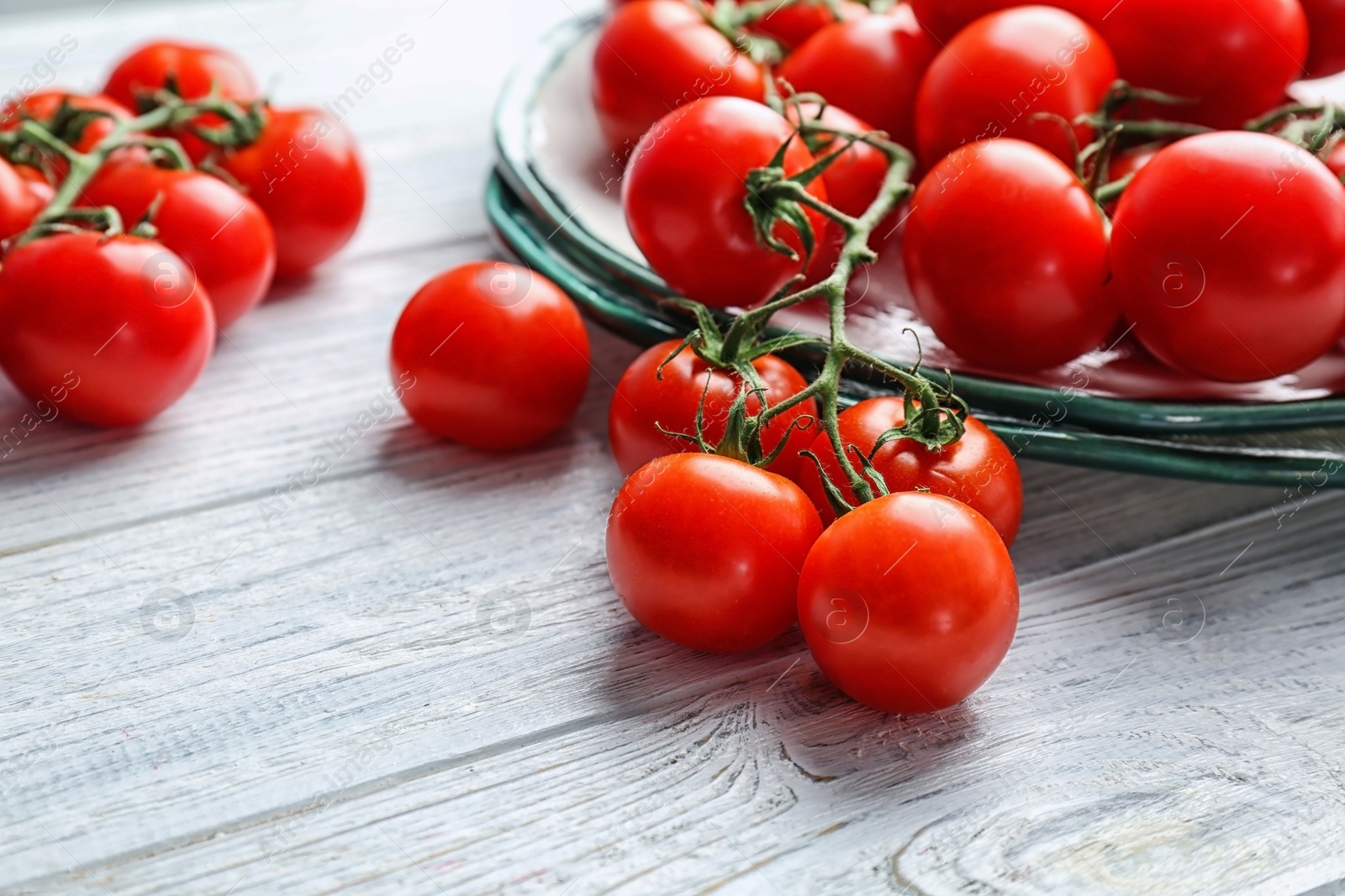 Photo of Fresh ripe red tomatoes on wooden table