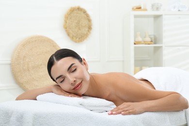 Photo of Beautiful young woman relaxing in spa salon