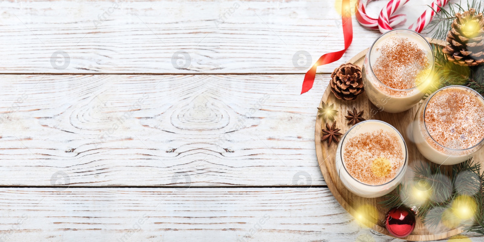 Image of Delicious Christmas cocktail with liqueur on white wooden table, flat lay with space for text. Banner design