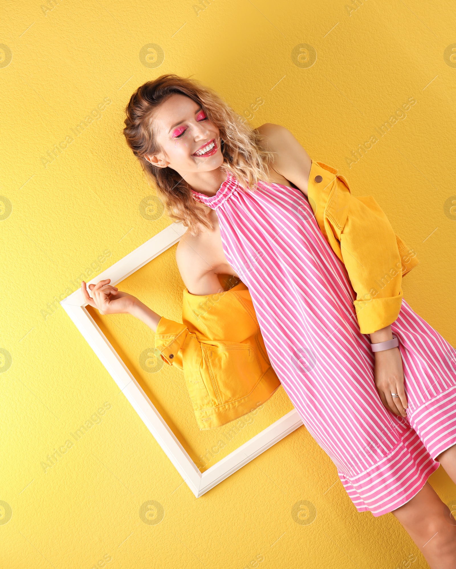 Photo of Beautiful young woman posing on color background. Summer fashion