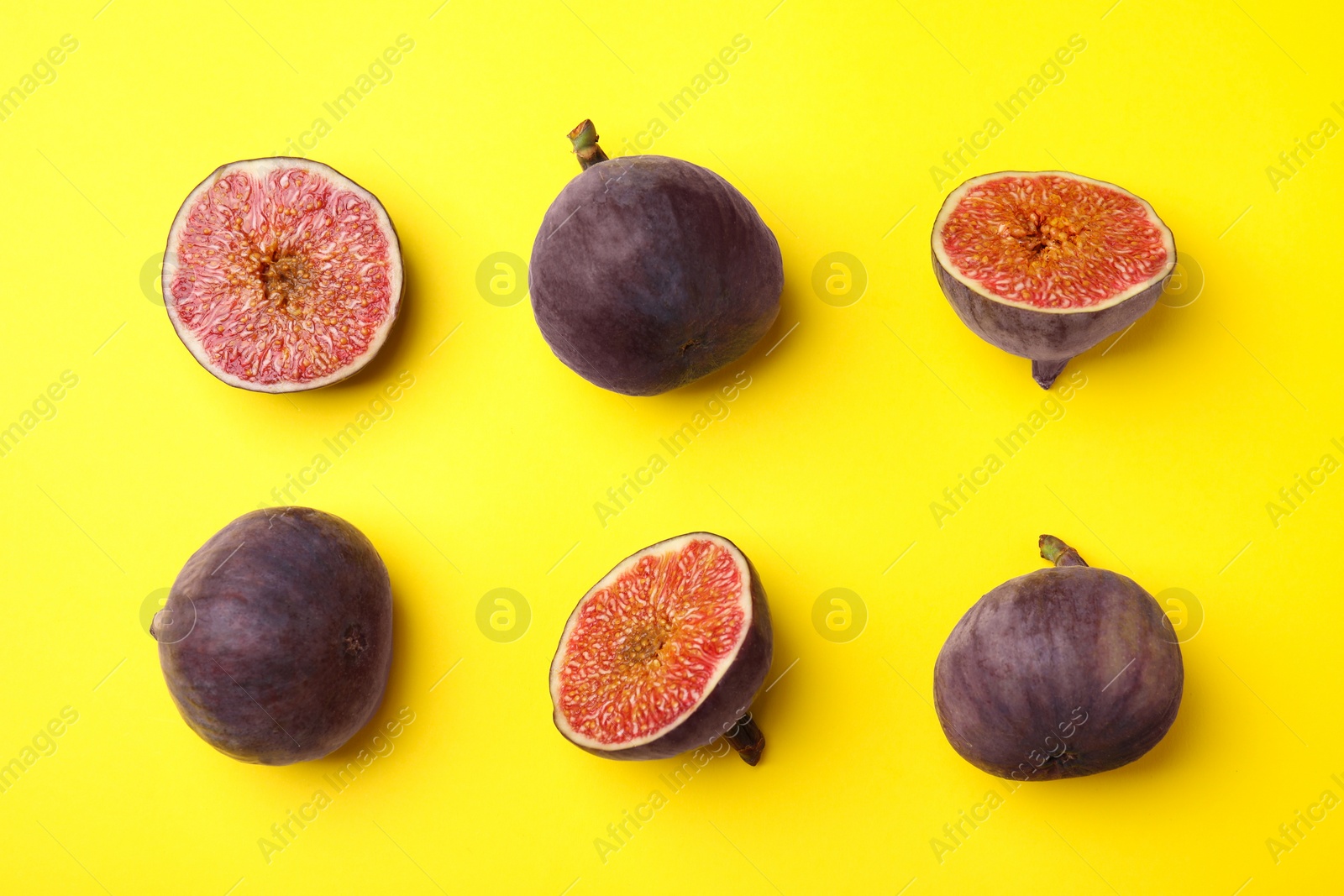 Photo of Fresh ripe figs on yellow background, flat lay
