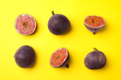 Fresh ripe figs on yellow background, flat lay