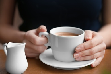 Photo of Woman with cup of aromatic coffee, closeup
