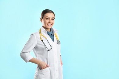 Photo of Pediatrician with stethoscope on turquoise background, space for text