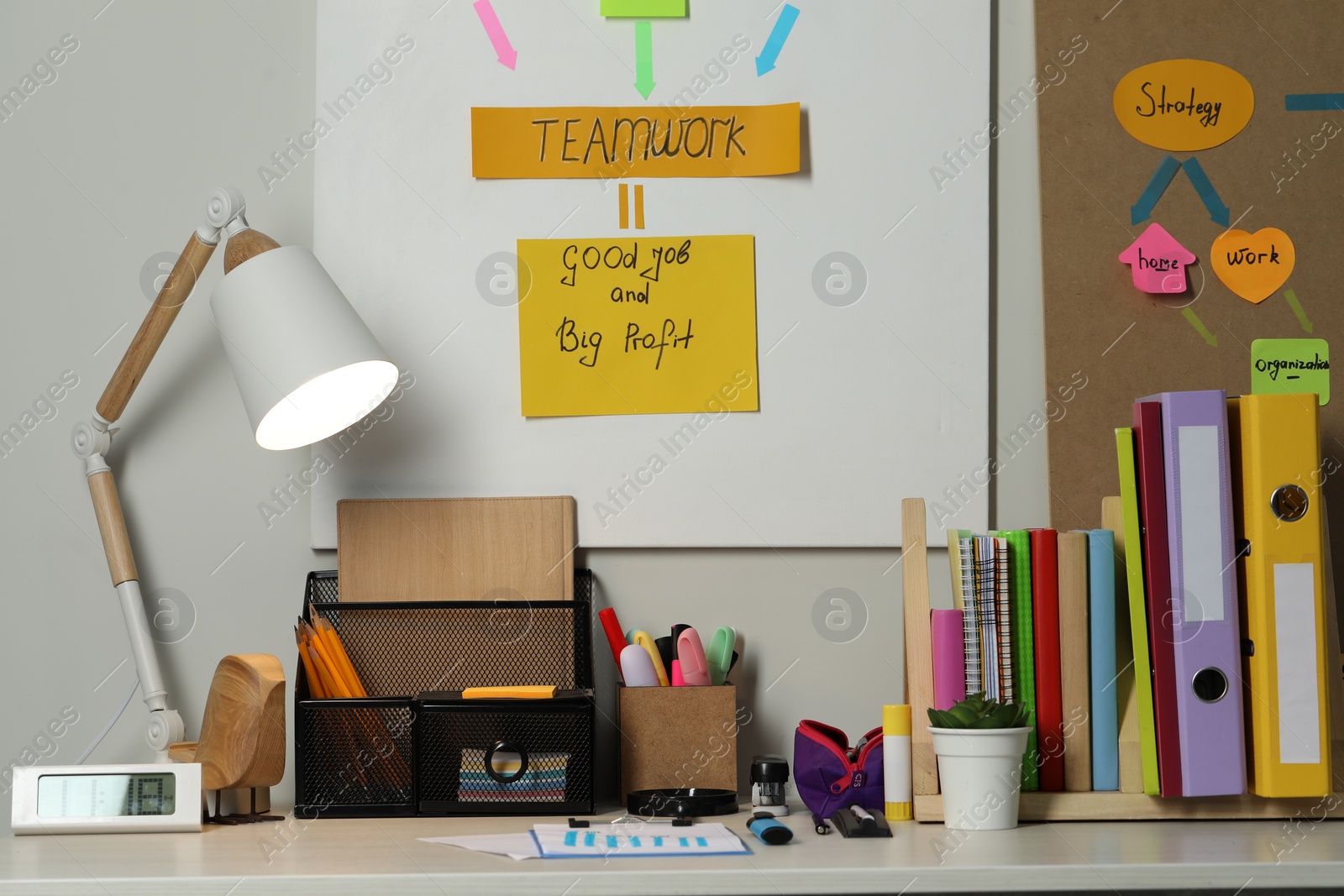 Photo of Business process planning and optimization. Workplace with lamp, colorful paper notes and other stationery on table