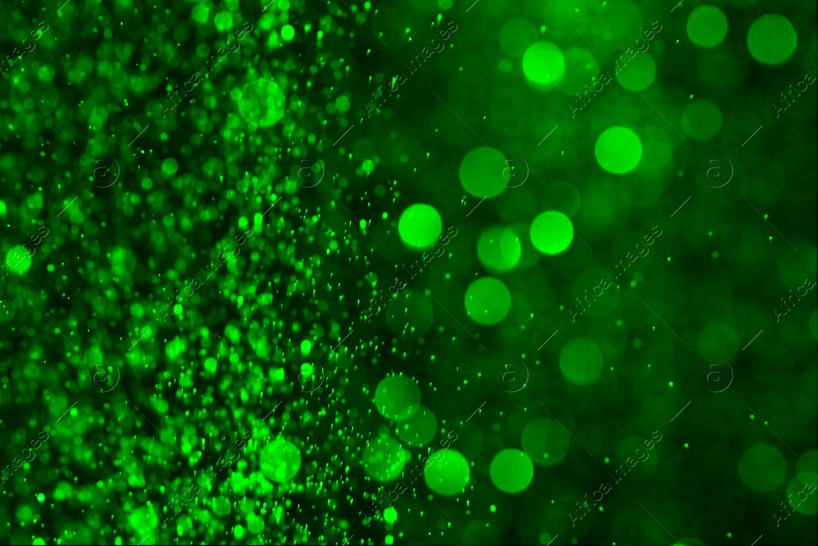 Image of St. Patrick day. Shiny green glitter on black background, bokeh effect