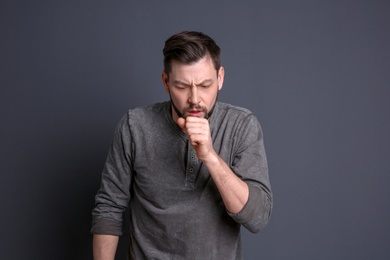 Photo of Mature man coughing on color background