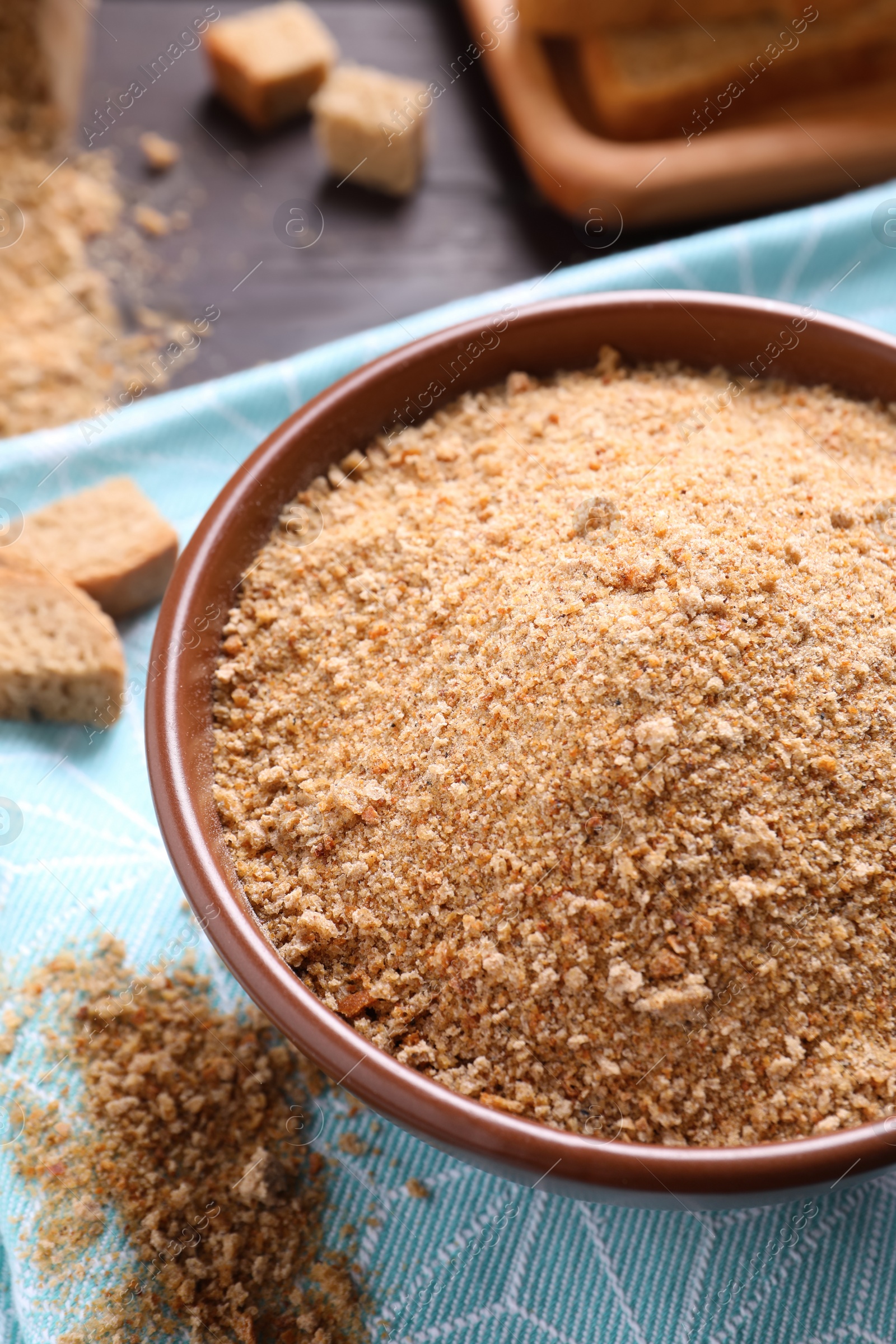 Photo of Fresh breadcrumbs in bowl on table, above view