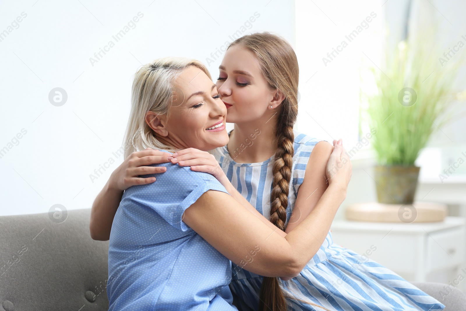 Photo of Mother and her adult daughter spending time together at home