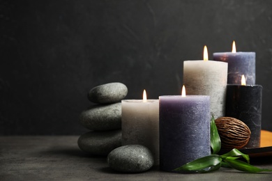 Photo of Spa composition with burning candles on table, space for text